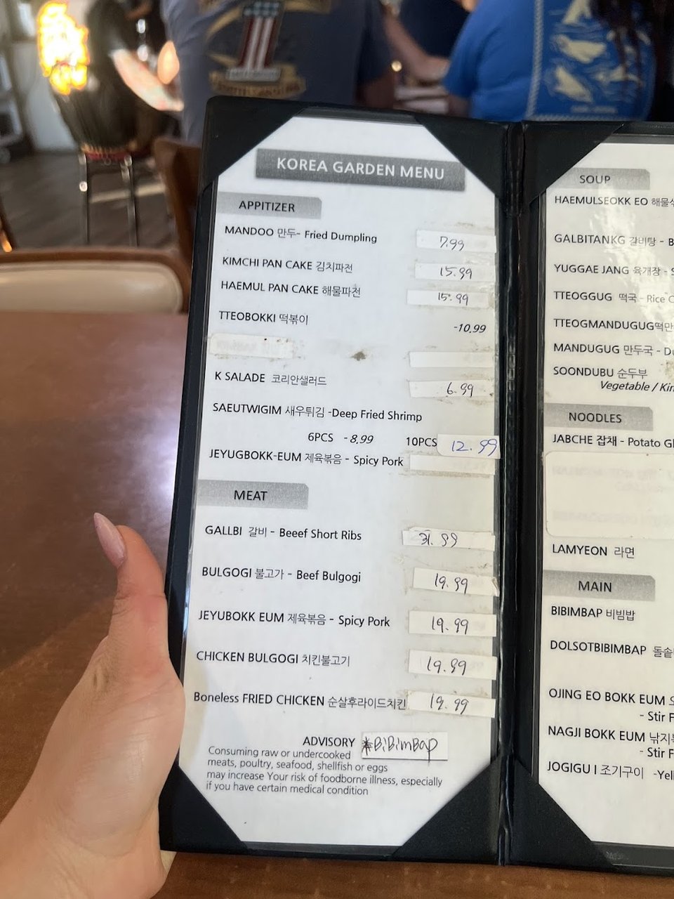 Menu layout featuring dumplings, noodles, and rice cakes.