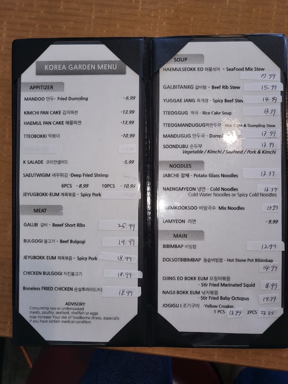 Printed menu showing noodles and stew dishes.